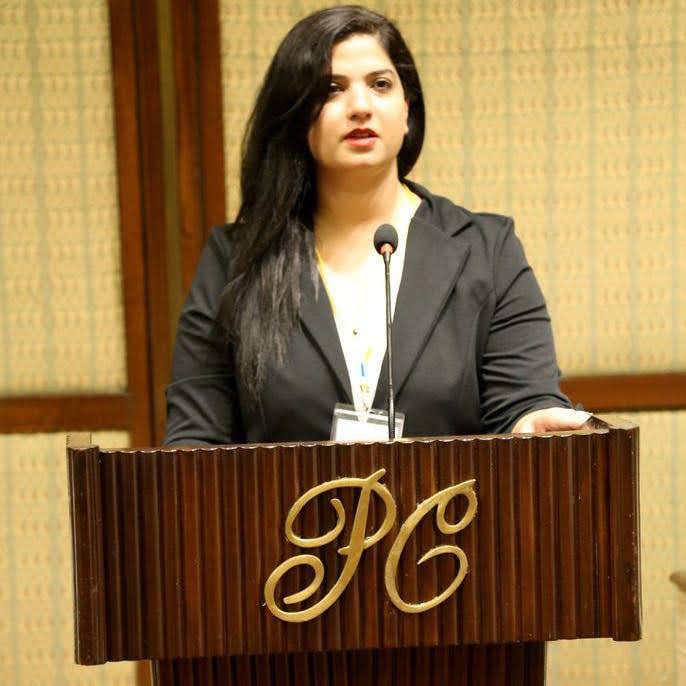 Dr. Ujala Akram speaking at a conference